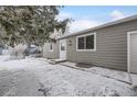 Well-maintained single-story home features neutral siding, white trim, and a snow-covered front yard at 10763 Lewis Cir, Broomfield, CO 80021