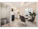 Bright, updated kitchen featuring white cabinets, stainless steel appliances, and a dining area with modern lighting at 10763 Lewis Cir, Broomfield, CO 80021