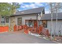 Inviting covered front entrance featuring custom railing and seating at 25601 Centennial Trl, Golden, CO 80401