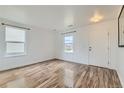 Bright living room with wood floors, ample natural light, and a modern design at 303 Diablo Pl, Brighton, CO 80603