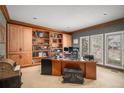 Inviting office with custom built-in shelving, large windows, and detailed wood trim throughout at 5442 S Dayton Ct, Greenwood Village, CO 80111
