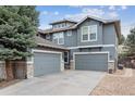 Three-car garage with an expansive driveway, exterior wood and stone detail, and a well-maintained lawn at 8406 Winter Berry Dr, Castle Pines, CO 80108