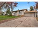 Charming home featuring a well-maintained front yard and an attached two-car garage on a sunny day at 784 W Sterne Pkwy, Littleton, CO 80120