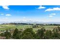 Picturesque landscape with stunning mountain views, surrounded by lush greenery and trees at 15295 E Cherry Creek S Rd, Larkspur, CO 80118