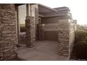 Covered porch with decorative stone pillars at the front of this charming home at 4746 Raven Run, Broomfield, CO 80023