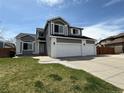Charming two-story home with a well-manicured lawn and three-car garage at 2050 Lake Circle Dr, Thornton, CO 80241