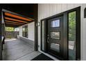 Contemporary front door with sidelights offering an inviting entrance and an interesting design at 6360 W 1St Ave, Lakewood, CO 80226