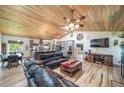 Open-concept living room featuring a wood ceiling, leather sofas, and a view into the kitchen at 1415 Isabell St, Golden, CO 80401
