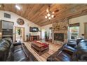 Spacious living room boasting vaulted wood ceilings, a stone fireplace, and hardwood floors at 1415 Isabell St, Golden, CO 80401