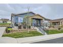 Inviting exterior view of a blue and stone accented home with a well-manicured lawn at 12930 Bobcat Ct, Broomfield, CO 80021