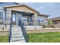 Close-up of the home's entrance, showing the porch, stone detailing, and welcoming entryway at 12930 Bobcat Ct, Broomfield, CO 80021