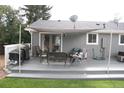Relaxing backyard deck with a grill, seating, and shade, perfect for outdoor enjoyment at 1008 Park View Ct, Castle Rock, CO 80104
