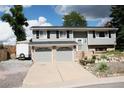 Charming two-story home with a two-car garage, gray siding, and landscaped front yard at 1008 Park View Ct, Castle Rock, CO 80104