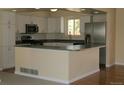 Updated kitchen showcases white cabinets, stainless steel appliances, and a breakfast bar for modern living at 1008 Park View Ct, Castle Rock, CO 80104