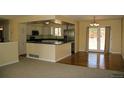 Bright, eat-in kitchen features white cabinets, stainless appliances, and a breakfast bar with countertop seating at 1008 Park View Ct, Castle Rock, CO 80104