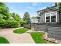 Attractive home exterior features lush landscaping, a stone-accented walkway, and complemented by mature trees enhancing curb appeal at 3748 Oakwood Dr, Longmont, CO 80503
