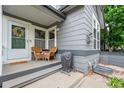 Inviting front porch featuring a cozy seating area with wicker chairs and a grill, creating a welcoming outdoor space at 3748 Oakwood Dr, Longmont, CO 80503