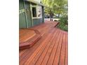 Well-maintained front porch area with a beautifully stained wooden deck and surrounding greenery at 13298 Alcott Cir, Broomfield, CO 80020