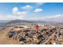 Aerial view of the apartment complex and surrounding community featuring mountain views and landscape at 10052 W Ute Pl # 202, Littleton, CO 80127