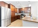 Well-equipped kitchen with stainless steel appliances, ample cabinet space, and a functional layout at 10052 W Ute Pl # 202, Littleton, CO 80127