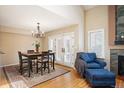 Inviting dining area featuring hardwood floors, a chandelier, and access to a patio or deck at 4605 S Yosemite St # 36, Denver, CO 80237