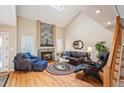 Bright living room boasts vaulted ceilings, a stone fireplace, and hardwood floors at 4605 S Yosemite St # 36, Denver, CO 80237