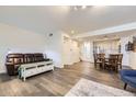 Bright living room and dining area with hardwood floors and modern lighting at 4555 S Auckland Ct, Aurora, CO 80015