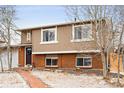 Beautiful home with a brick and siding exterior, well-kept lawn and landscaped yard at 9240 W Wagon Trail Dr, Littleton, CO 80123