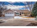 Ranch-style home with a two-car garage and snow-covered yard at 2517 S Eldridge Ct, Lakewood, CO 80228