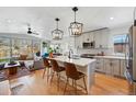 Open kitchen with quartz countertops, stainless steel appliances, and stylish pendant lighting at 949 Raleigh St # 2, Denver, CO 80204