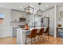 Modern kitchen featuring white cabinets, quartz countertops, and stainless steel appliances at 949 Raleigh St # 2, Denver, CO 80204
