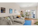 Inviting living room featuring a comfortable sectional sofa and view of the entry door at 8073 W 51St Pl # 303, Arvada, CO 80002