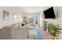 Bright living room with a large sectional sofa, fireplace and a view of the entry door at 8073 W 51St Pl # 303, Arvada, CO 80002