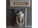 Up close image of antique door knocker and mail slot on dark wooden door at 1817 - 1821 Vine Vine St, Denver, CO 80206