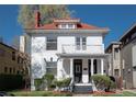 Beautiful home with red tile roof, white exterior, and inviting front porch at 1817 - 1821 Vine Vine St, Denver, CO 80206