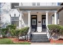 Charming front entry with double doors, white columns, and manicured landscaping at 1817 - 1821 Vine Vine St, Denver, CO 80206