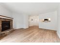 Cozy living room features a stone fireplace and open view to the kitchen at 3600 S Pierce St # 1-104, Lakewood, CO 80235