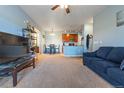 The living room is open to the kitchen and features plush carpeting at 2682 S Cathay Way # 307, Aurora, CO 80013