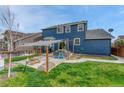 Backyard patio with shade, ideal for outdoor entertaining and dining on a well manicured lawn at 3367 Dove Valley Pl, Castle Rock, CO 80108