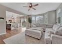 Bright living room with plush seating, large windows, and an open view of the modern kitchen at 3367 Dove Valley Pl, Castle Rock, CO 80108