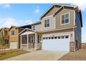 Two-story house with gray siding, white garage door, and a front porch at 6530 13Th St, Frederick, CO 80530