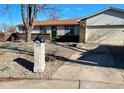 Inviting ranch style home featuring decorative rock landscaping, a brick mailbox, and 2 car garage at 3190 S Joplin Ct, Aurora, CO 80013