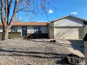 Inviting single-story home with decorative rock, a 2-car garage, and mature trees at 3190 S Joplin Ct, Aurora, CO 80013