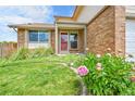 Inviting front porch with a red door and well-maintained landscaping at 11149 Seton Pl, Westminster, CO 80031