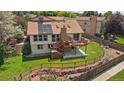 Back exterior showcasing a deck, patio, large yard with mature trees and solar panels at 11149 Seton Pl, Westminster, CO 80031