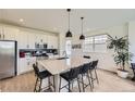 Modern kitchen featuring an island with seating, stainless steel appliances, and bright cabinets at 8982 Spaulding St, Parker, CO 80134