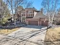 Spacious home features a three-car garage, wide driveway, and mature trees for shade at 6406 Eagle Ct, Longmont, CO 80503