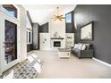 Bright living room with fireplace and tall ceilings offers natural light and comfortable atmosphere at 6406 Eagle Ct, Longmont, CO 80503
