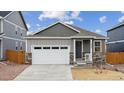 Charming single-story home with gray siding, stone accents, and a two-car garage at 6500 13Th St, Frederick, CO 80530