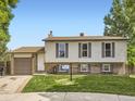 Charming two-story home with vinyl siding, brick accents, landscaped lawn, and an attached garage at 11062 Hudson Ct, Thornton, CO 80233
